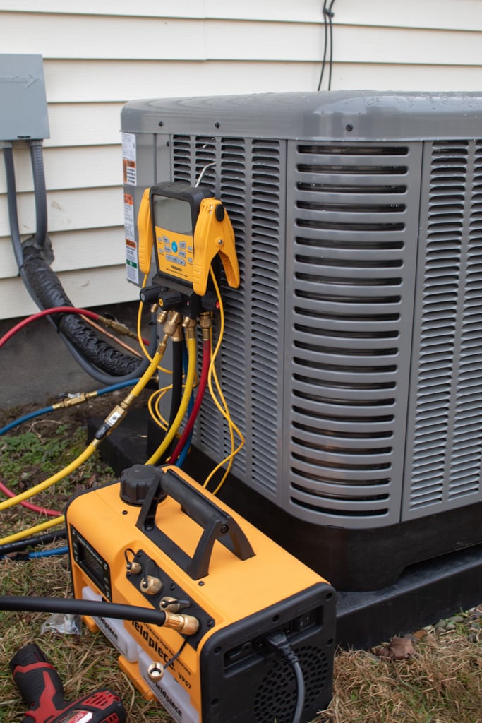 Diagnostic gauges and testing equipment connected to an outdoor air conditioner during Honest Fix AC service in Steubenville, Ohio.