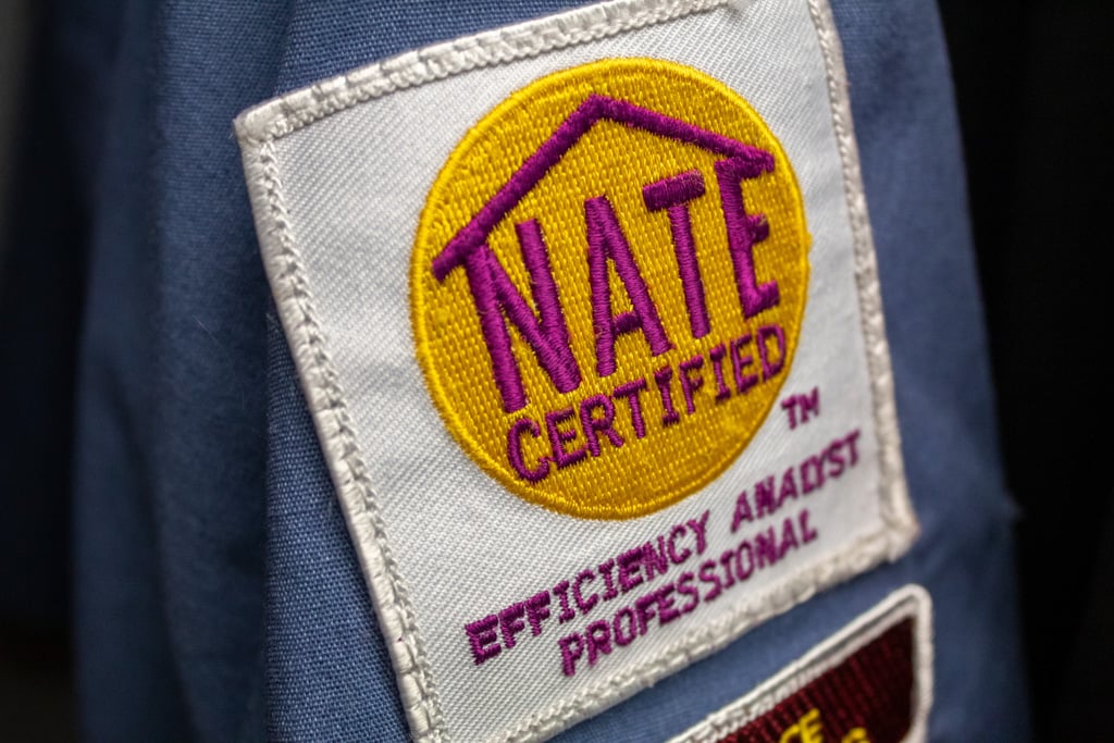 Close-up of NATE Certified patch on an Honest Fix technician uniform.