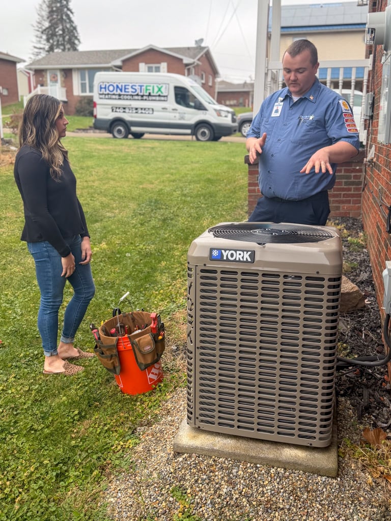 Honest Fix owner Alex Largent explaining air conditioner recommendations to a homeowner outside a home in Steubenville, Ohio.