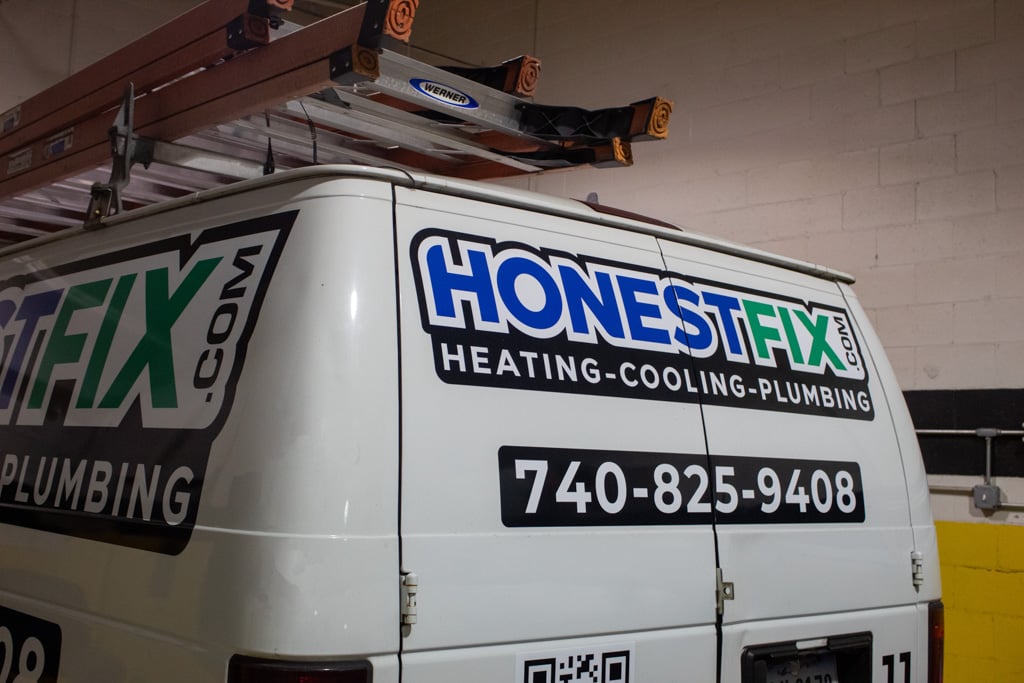 Honest Fix service van showing company branding and phone number.