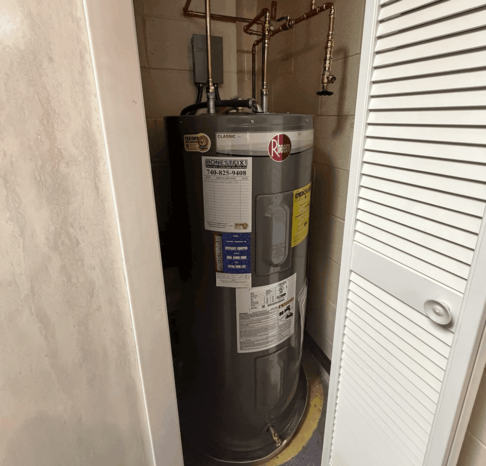 Rheem Classic water heater installed by Honest Fix in a Weirton, West Virginia home, with copper supply lines and Honest Fix service magnet on the tank