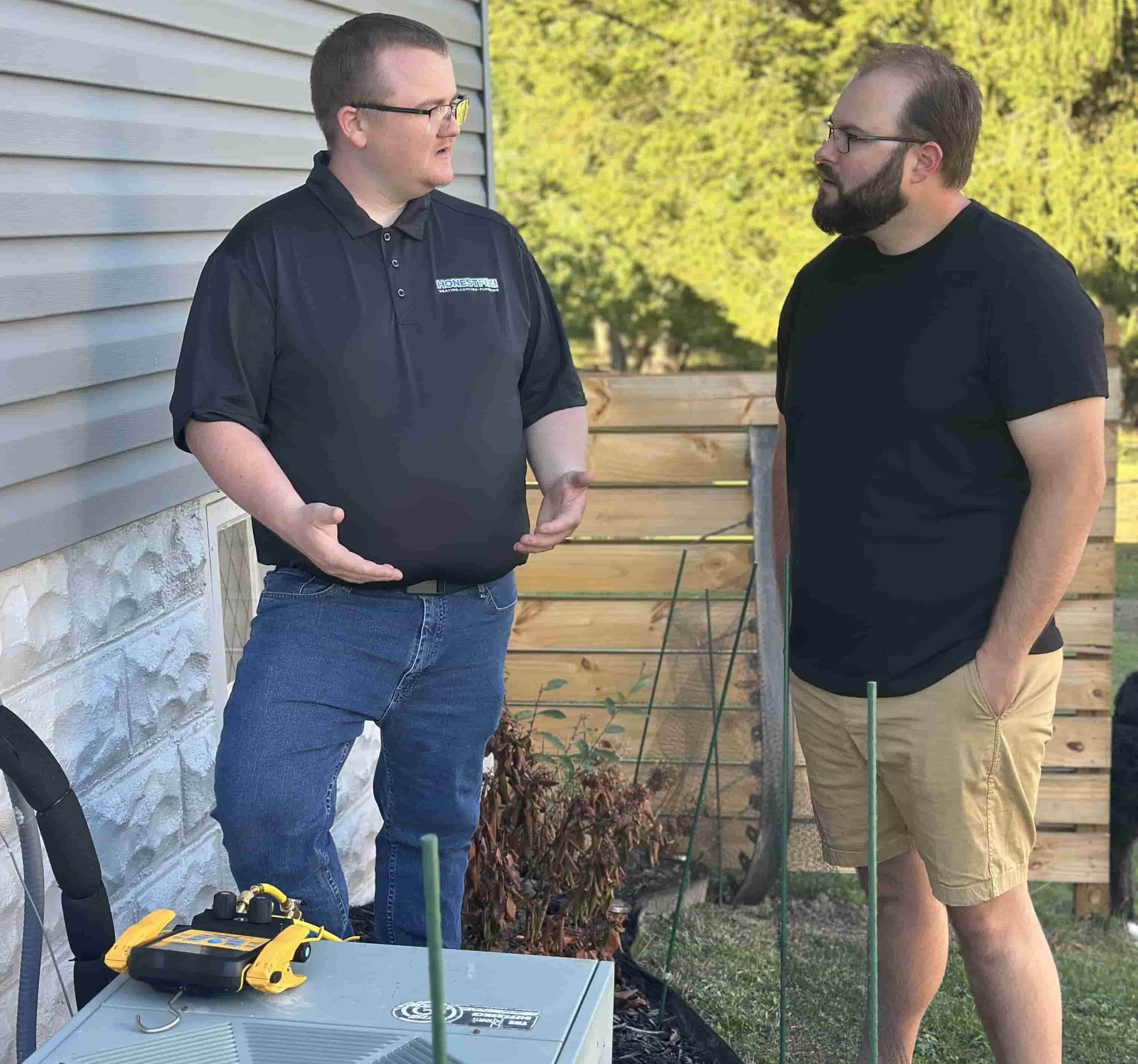 Owner Alex Largent of Honest Fix Heating, Cooling & Plumbing consulting with a homeowner about air conditioner repair in Steubenville, OH.