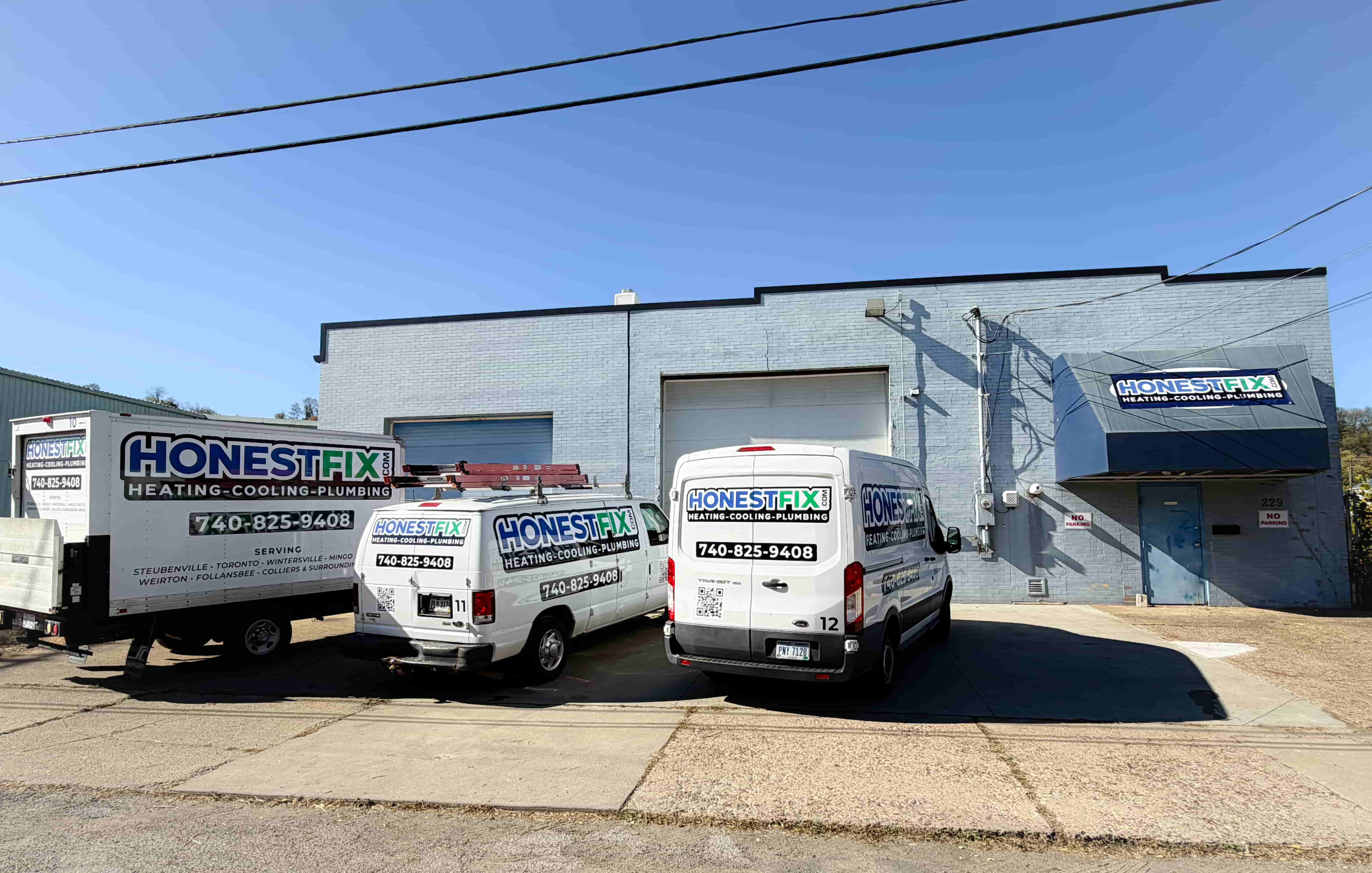 Honest Fix Heating, Cooling & Plumbing service vans parked outside the company headquarters in Steubenville, OH.