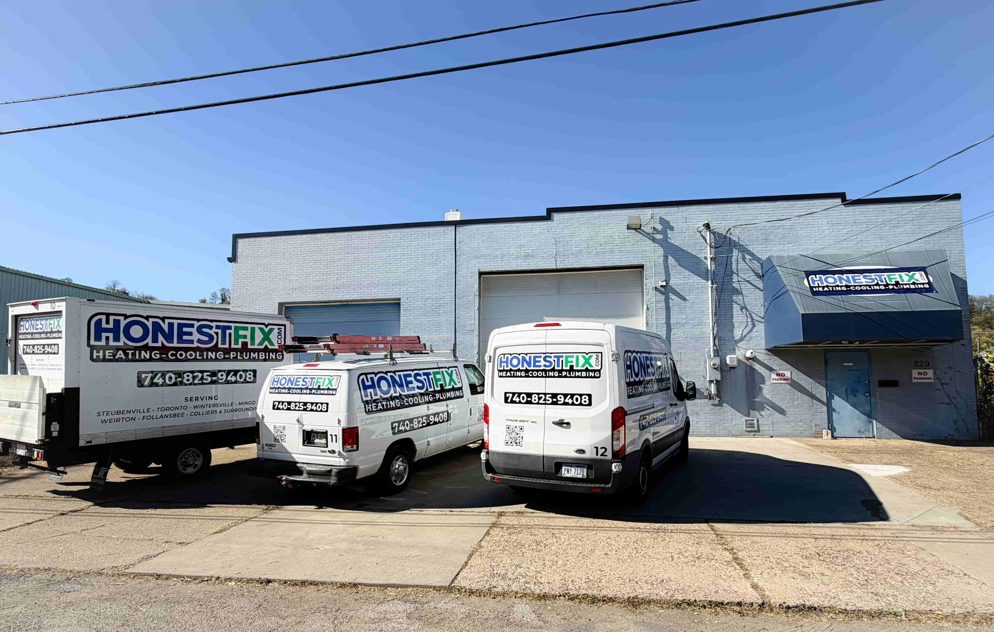 Honest Fix Heating, Cooling & Plumbing service vans parked outside the company headquarters in Steubenville, OH.