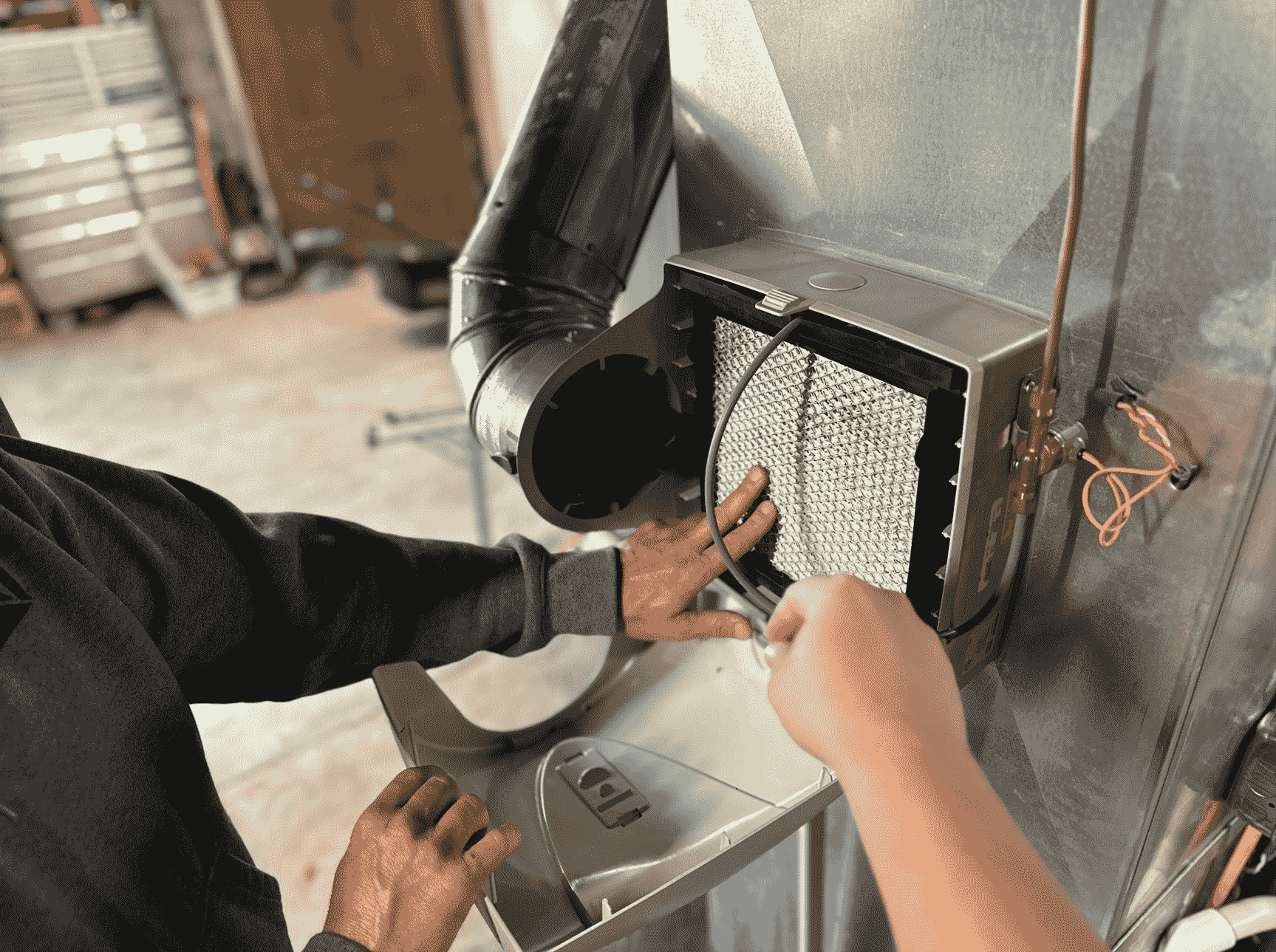 Honest Fix Heating, Cooling & Plumbing technician installing a whole-home humidifier filter on a furnace system in Steubenville, OH.